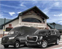 a black gmc van and a black gmc van parked in front of a building